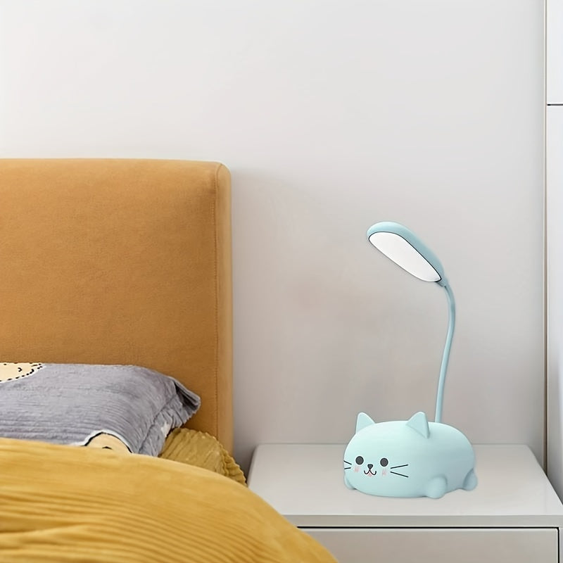 Light blue cat-shaped desk lamp on a nightstand next to a bed with yellow bedding.