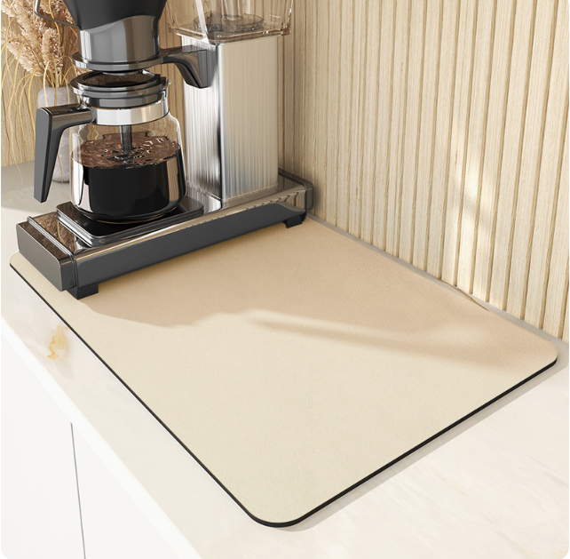 Coffee maker on a beige mat with a neutral background