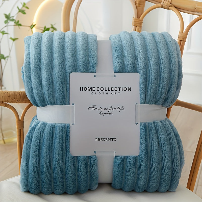 Blue textured throw blanket with a label on a chair