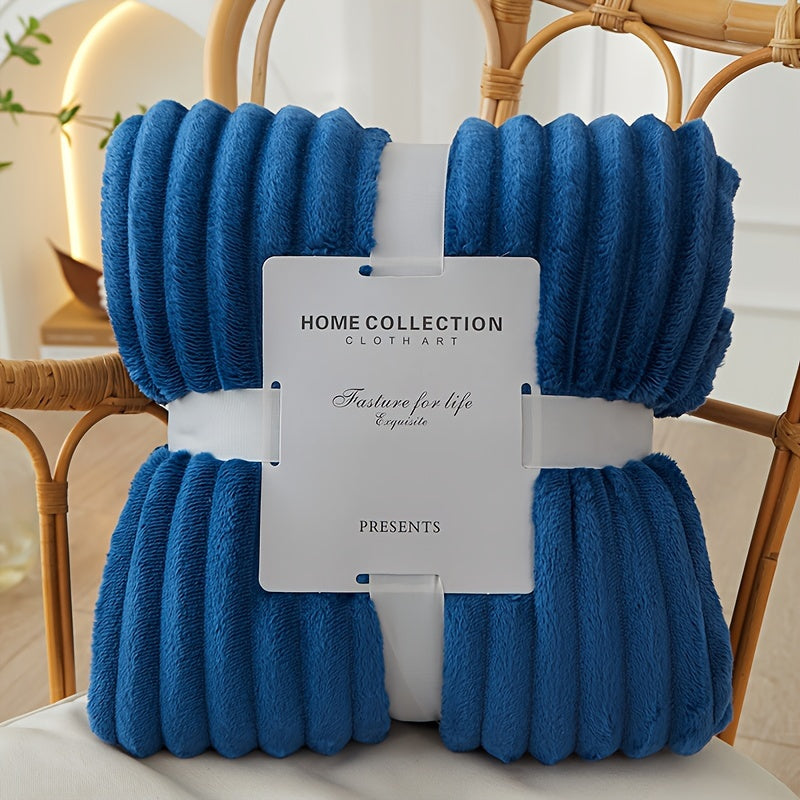Blue textured blanket with a Home Collection label on a chair.