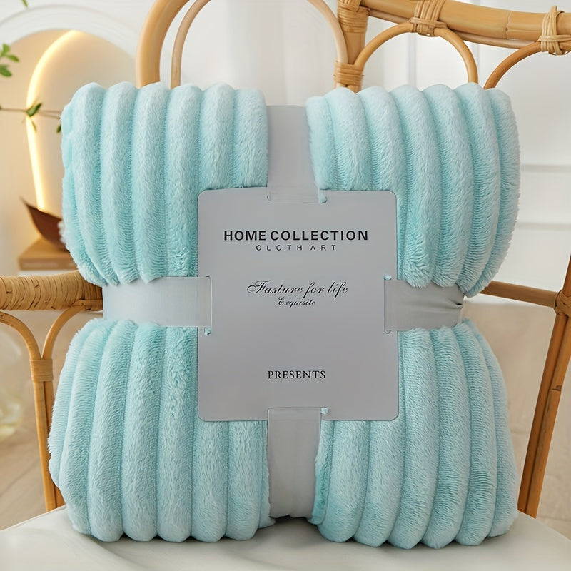 Light blue textured throw blanket with a label on a chair