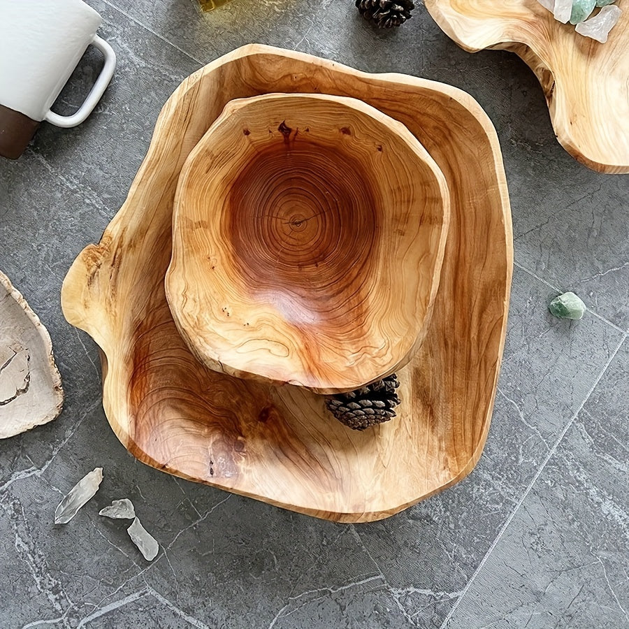 Wooden bowls with a natural, rustic finish on a gray stone surface.