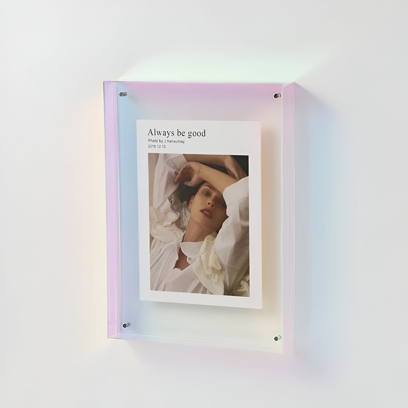 Framed photo with 'Always be good' text on a wall with a gradient light effect
