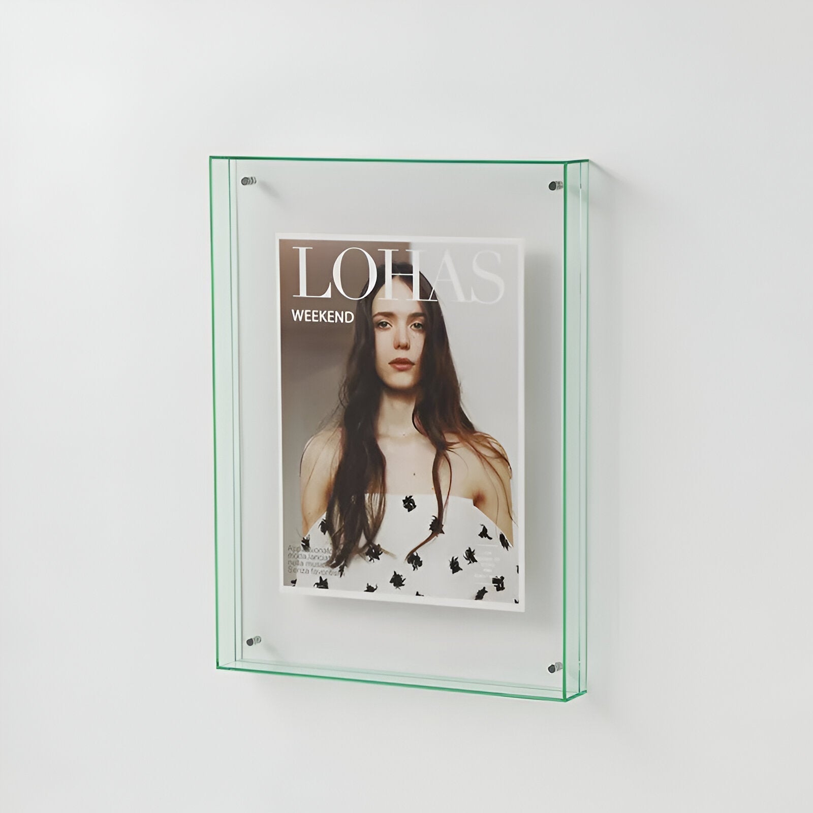 Glass-framed magazine cover with a woman on a white background