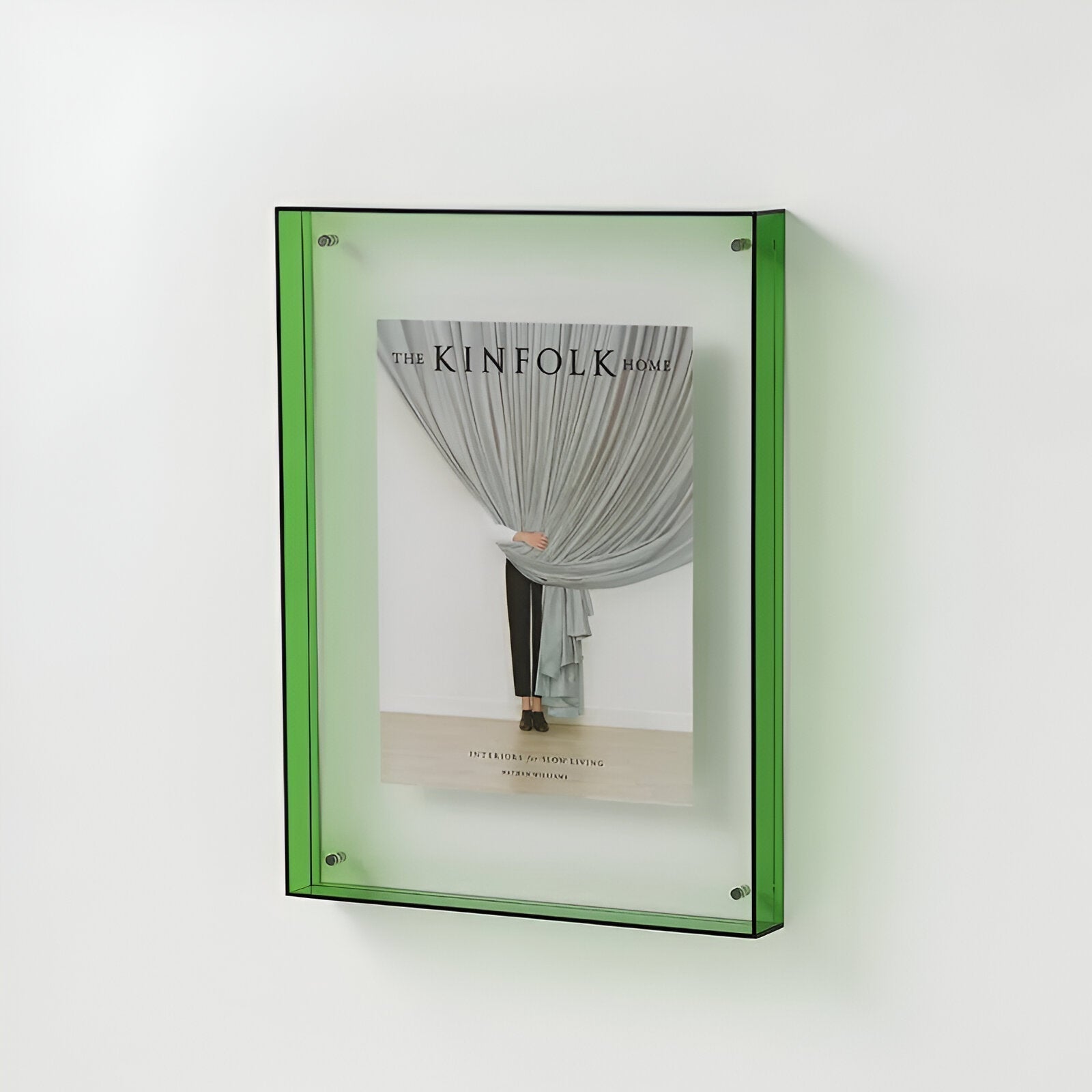 Green-framed book titled 'The Kinfolk Home' on a white background