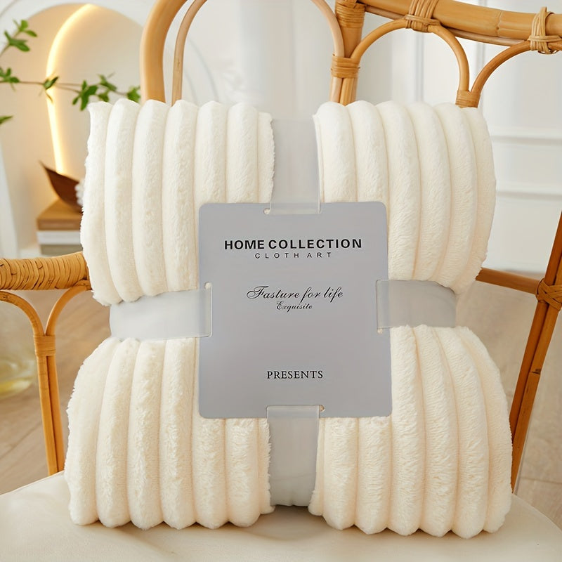 Folded white blanket with a label on a wicker chair