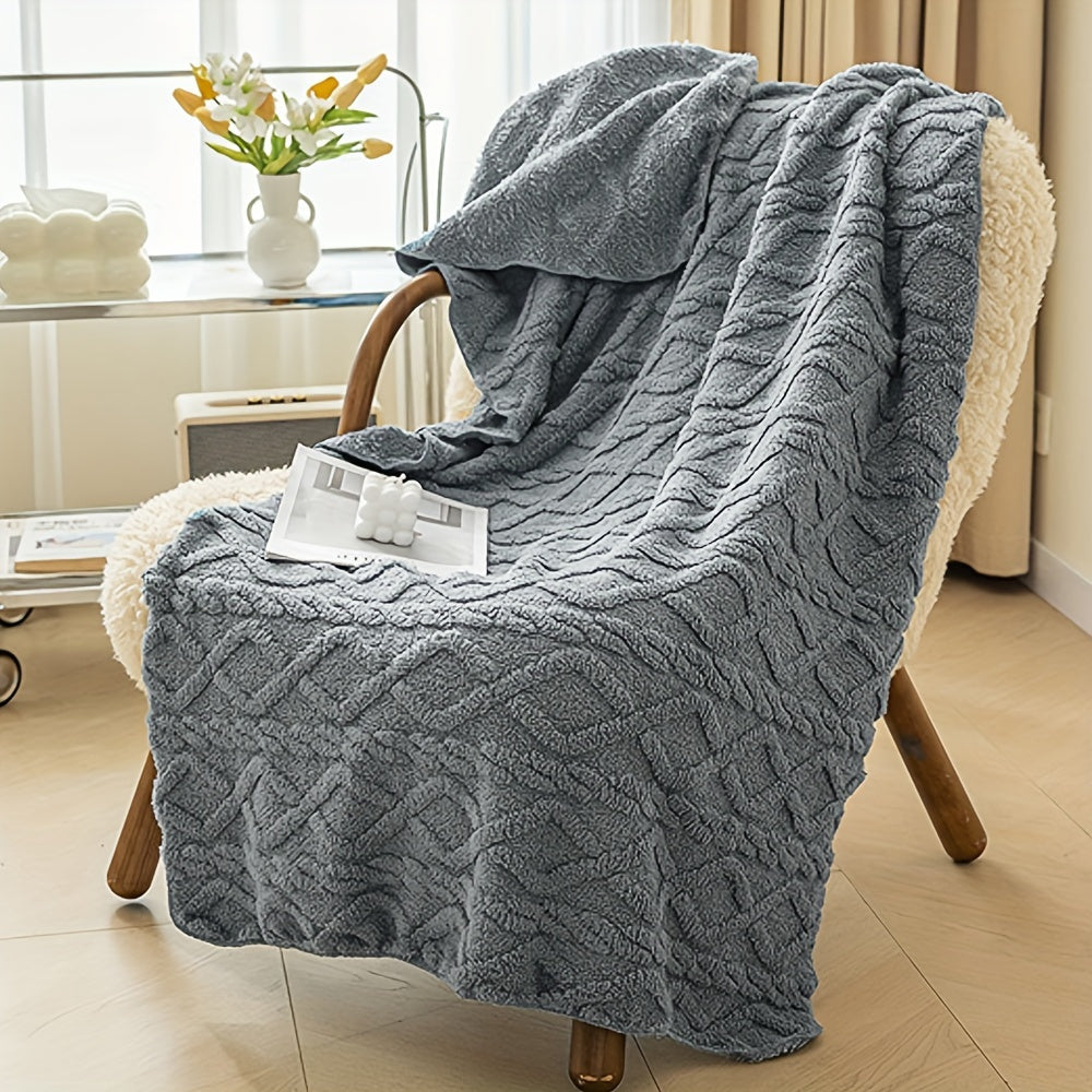Gray textured blanket draped over a chair in a cozy living room setting.