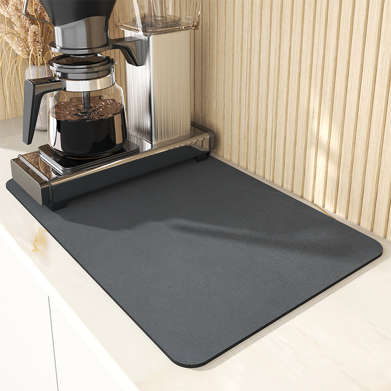 Gray mat on a kitchen counter with a coffee maker on top