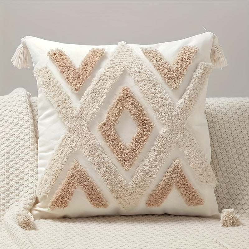 Decorative pillow with geometric pattern and tassels on a neutral background