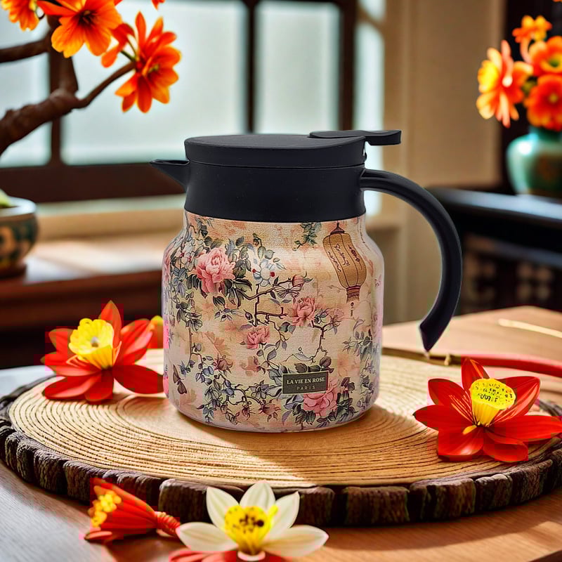 Floral-patterned thermos mug on a wooden surface with flowers in the background