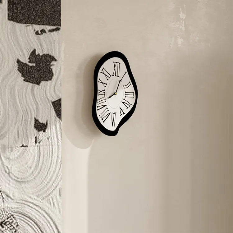 Black and white wall clock on a textured beige wall