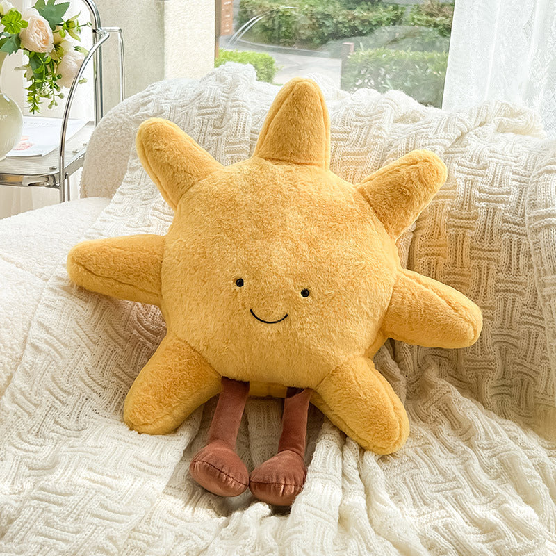 Yellow plush star toy on a textured surface with a blurred background