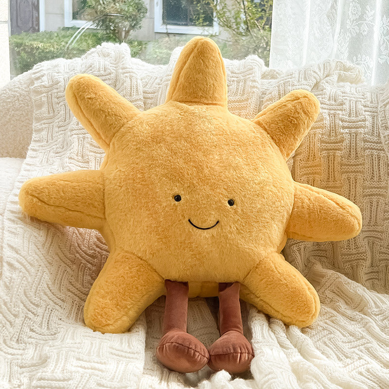 Yellow plush star toy with a smiling face on a textured surface