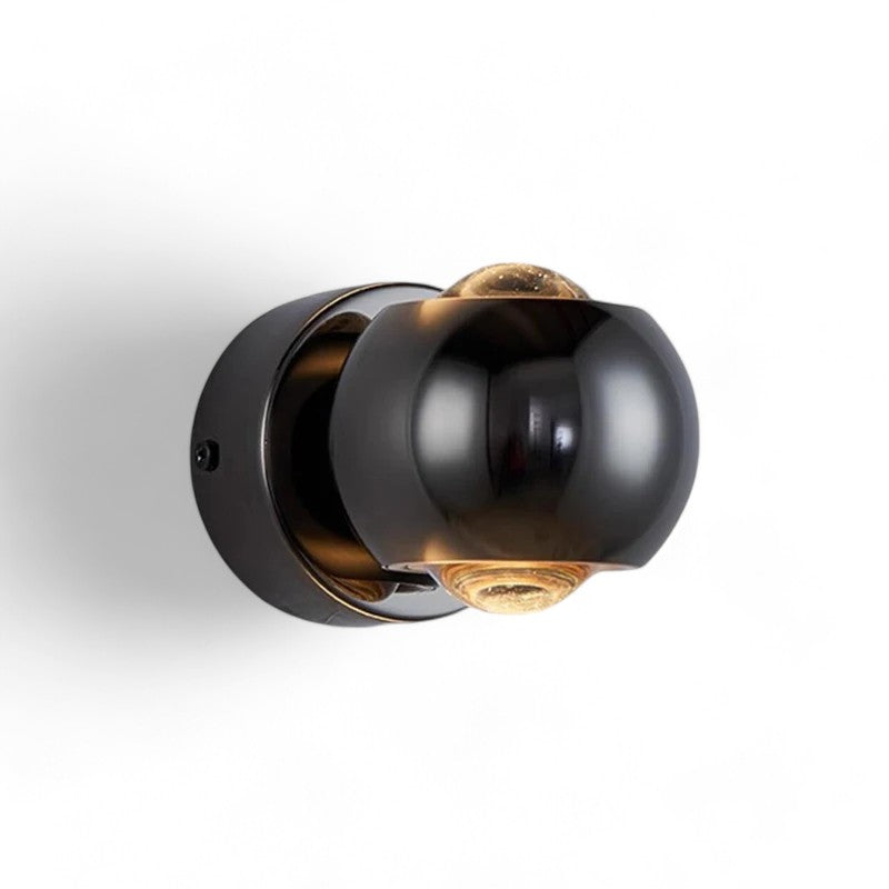 Modern wall light fixture with black and gold design on a white background