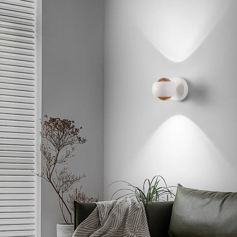Modern wall sconce on a gray wall with decorative elements.