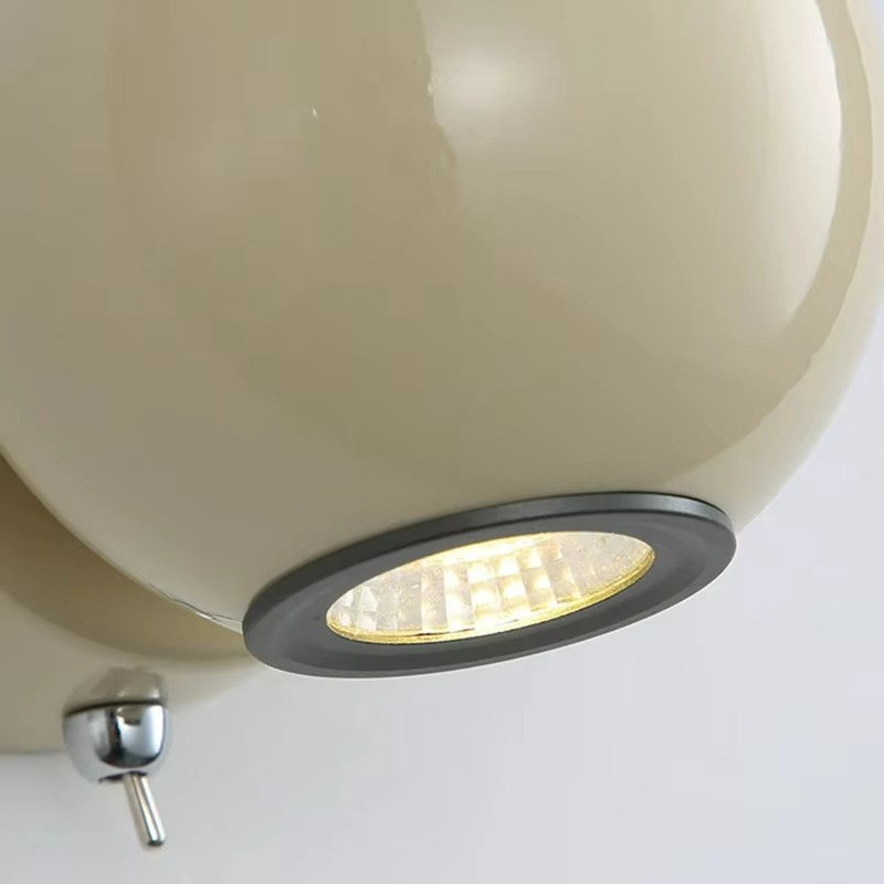 Ceiling light fixture with beige shade and metallic base on a white background