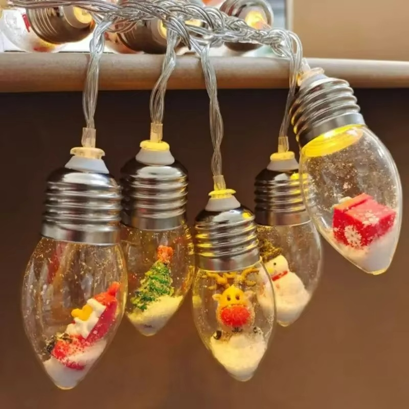 String lights with decorative bulbs featuring small figurines on a brown background