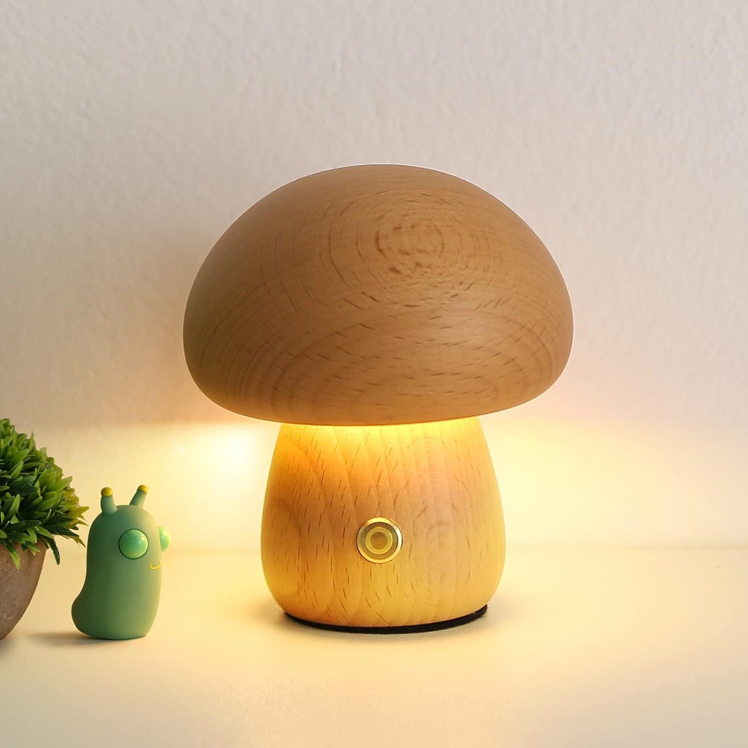 Mushroom-shaped lamp emitting a warm glow on a light background