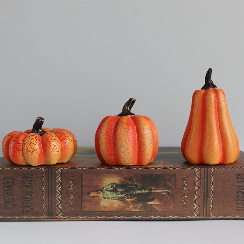 Three decorative pumpkins on a vintage book with a gray background