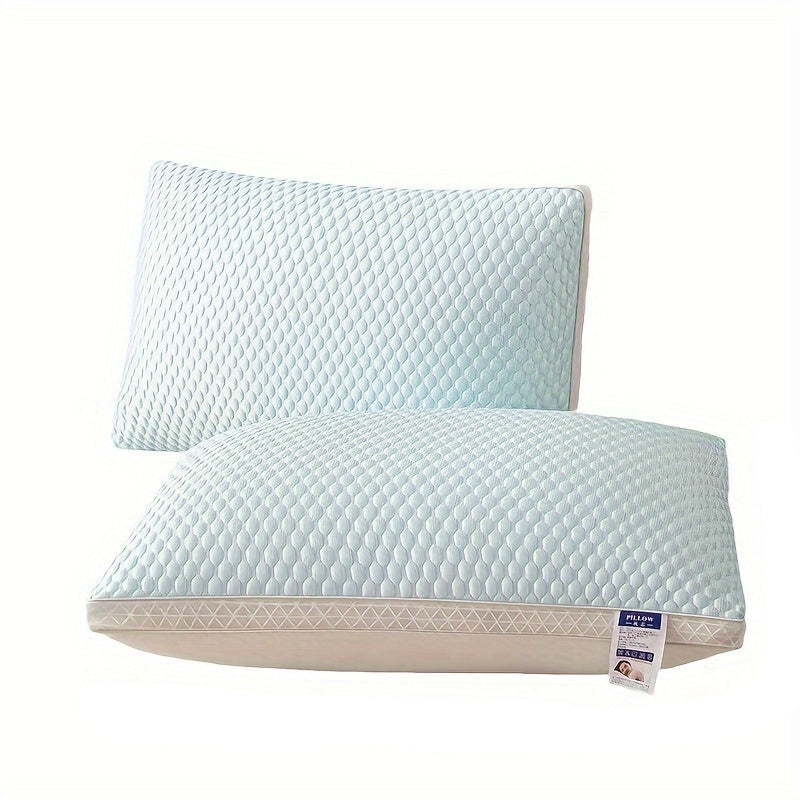 Two light blue pillows with measurements on a white background