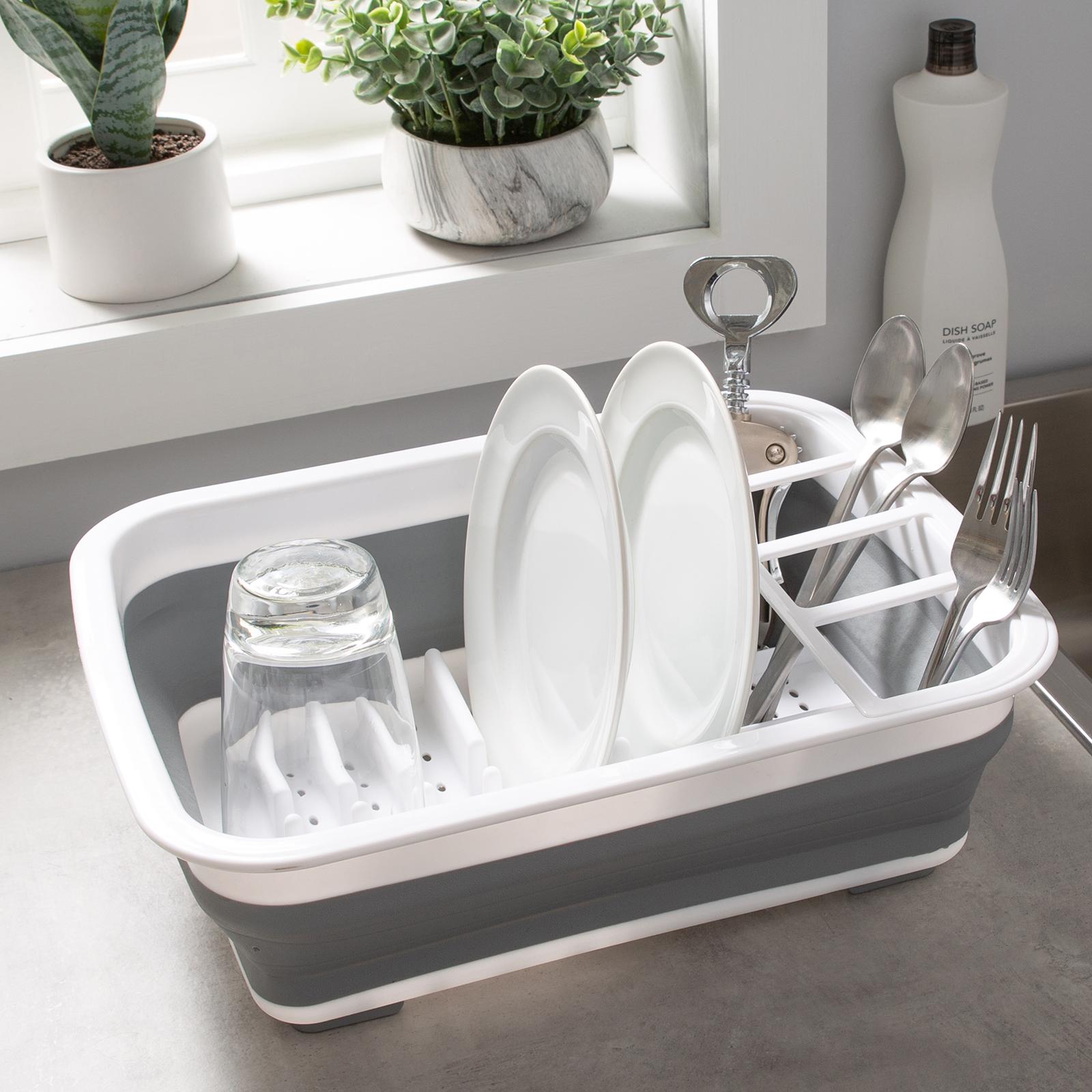 Collapsible dish drying rack with dishes on a kitchen counter.