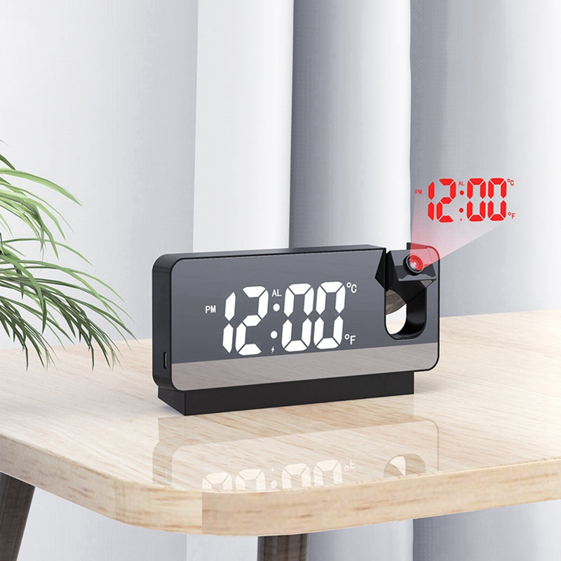 Digital clock projecting time on a wall with a plant in the background