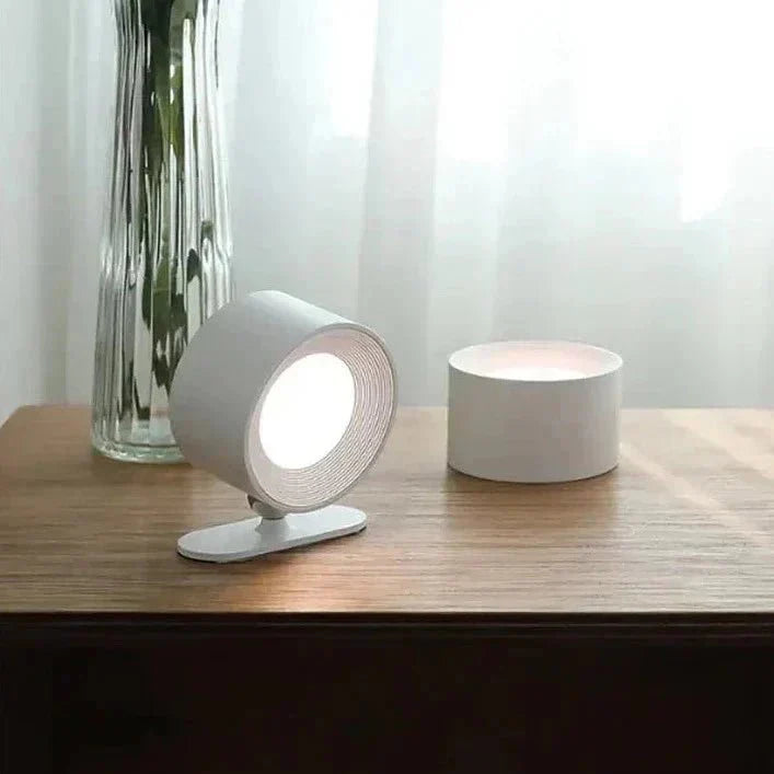Modern table lamp on a wooden surface with a blurred background
