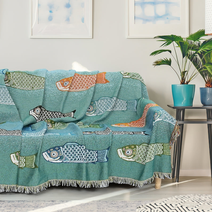 Teal sofa cover with fish patterns in a living room setting