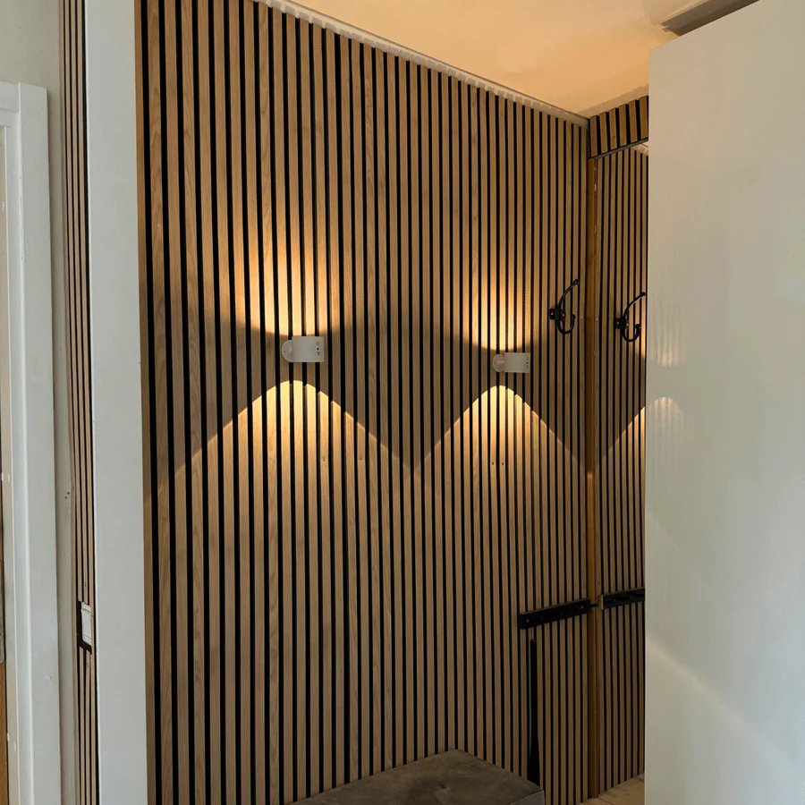 Wooden slat wall with lighting fixtures in a modern interior setting