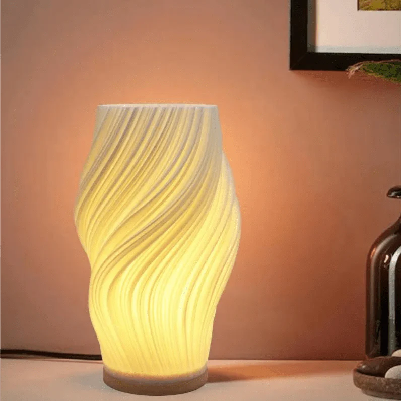 Decorative table lamp with wavy design on a warm-toned background