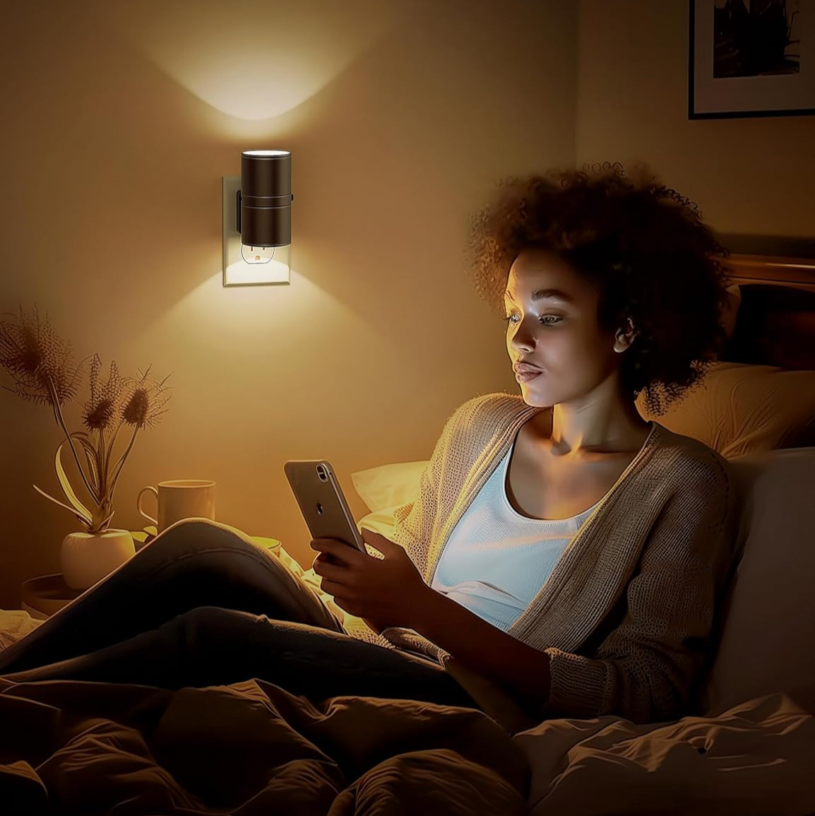 Woman using a smartphone in a dimly lit room with a soft glow light fixture.