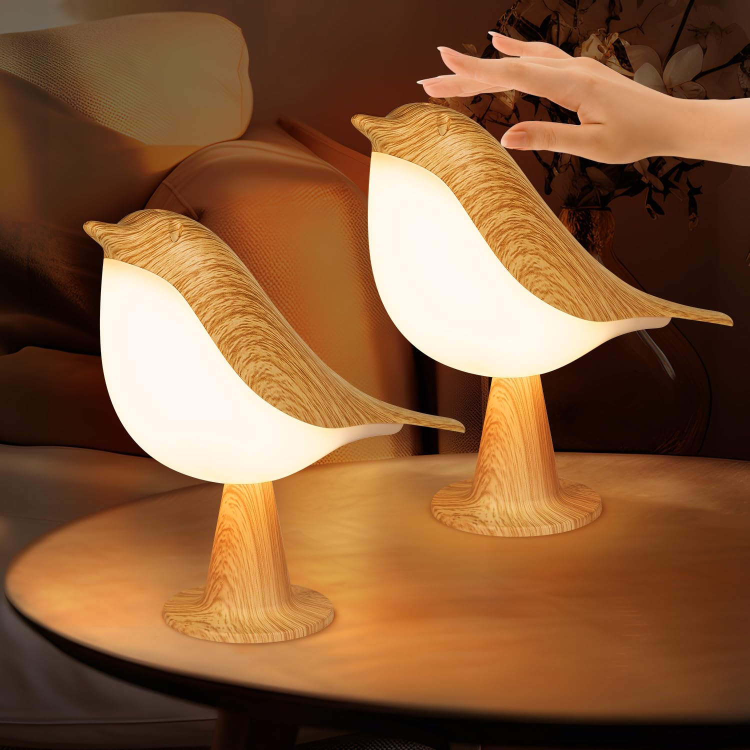 Two bird-shaped lamps on a table with a blurred background