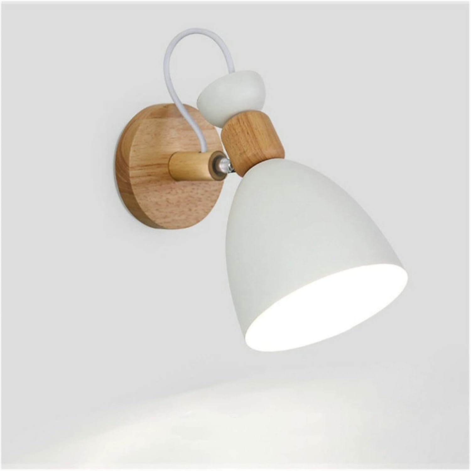 Wall-mounted light fixture with white shade and wooden base on a light gray background