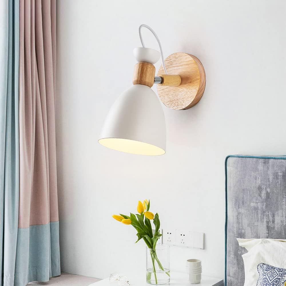Wall-mounted lamp with a white shade and wooden base in a room setting.
