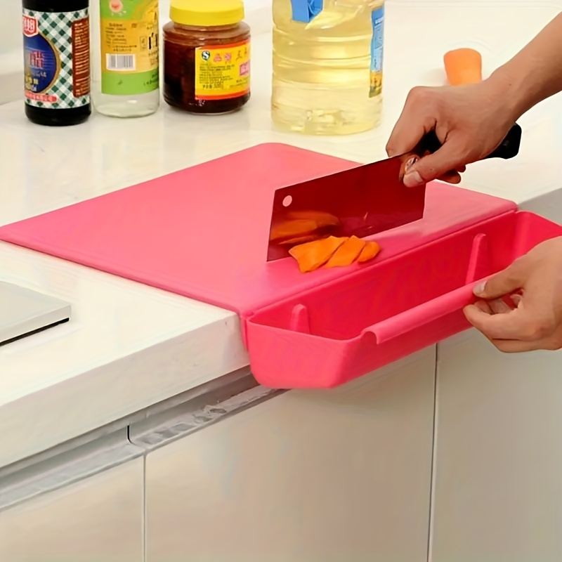 Person using a pink cutting board with a knife to slice carrots on a kitchen counter.