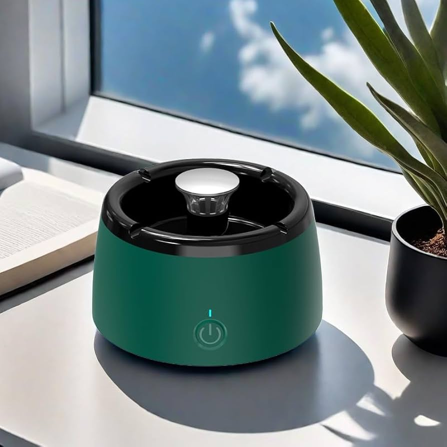 Green humidifier on a desk with a plant and book in the background
