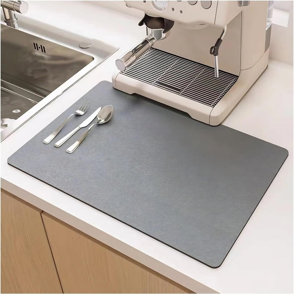 Gray placemat on a kitchen counter with cutlery and an espresso machine.