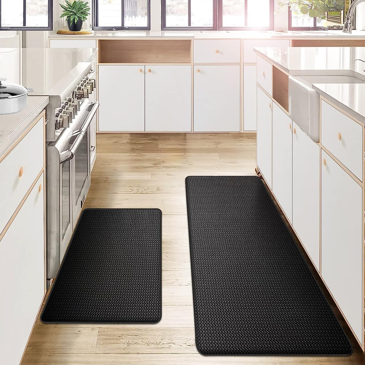 Black kitchen mats on a wooden floor in a modern kitchen.