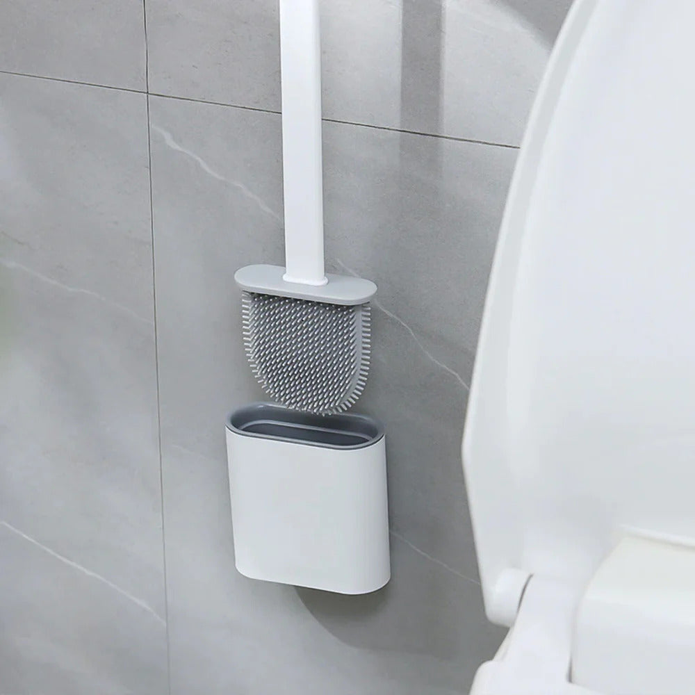 White toilet brush with holder mounted on a tiled bathroom wall.