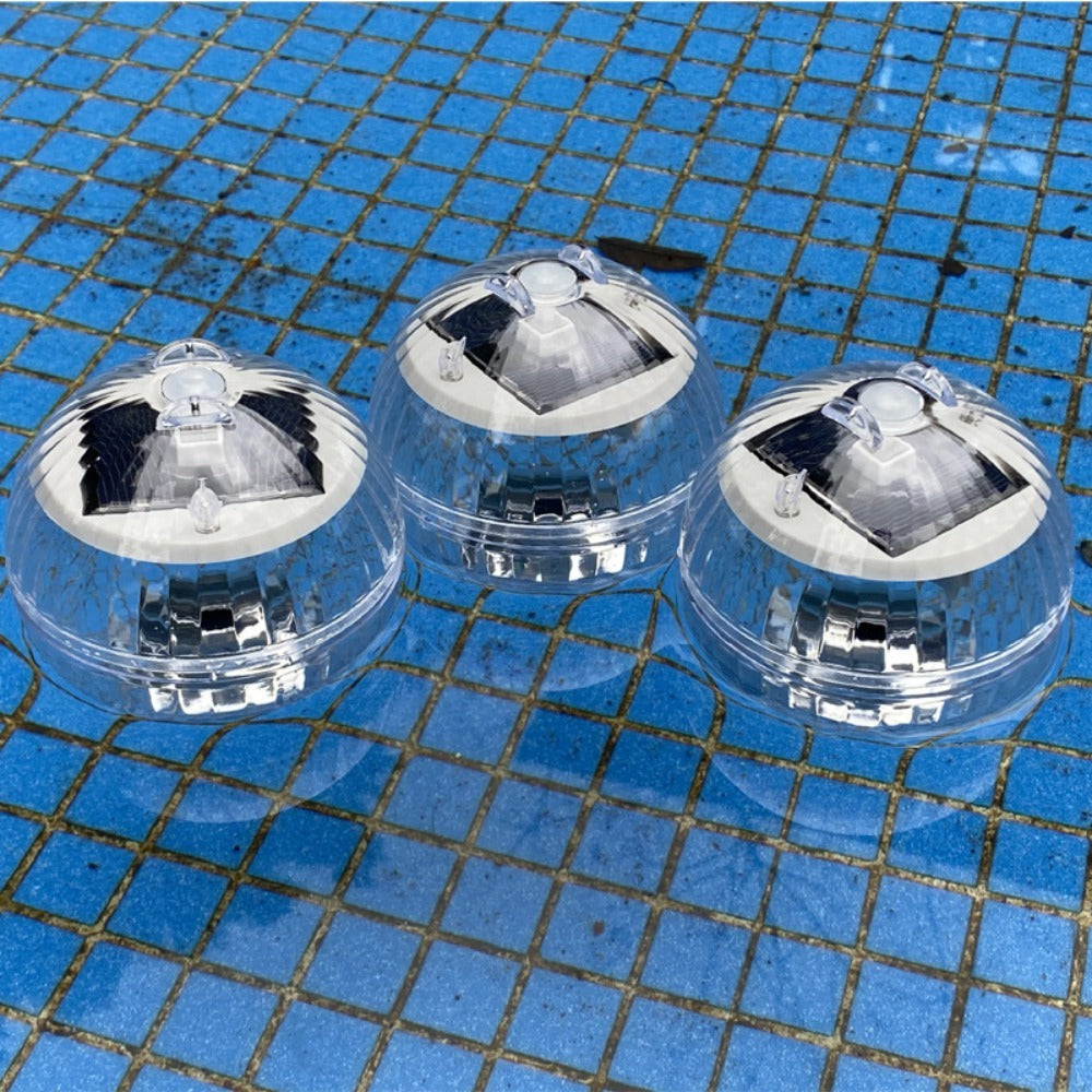 Three solar lights on a blue tiled surface