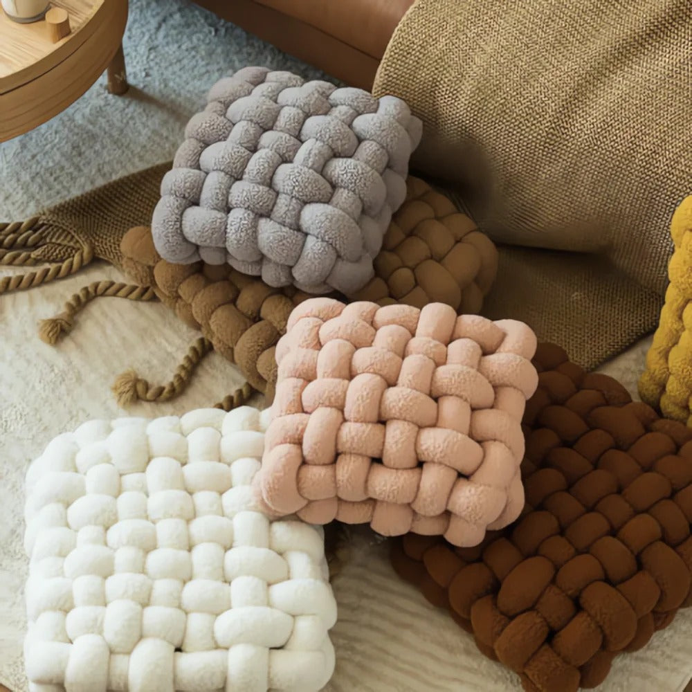 Textured square cushions in various colors on a soft surface