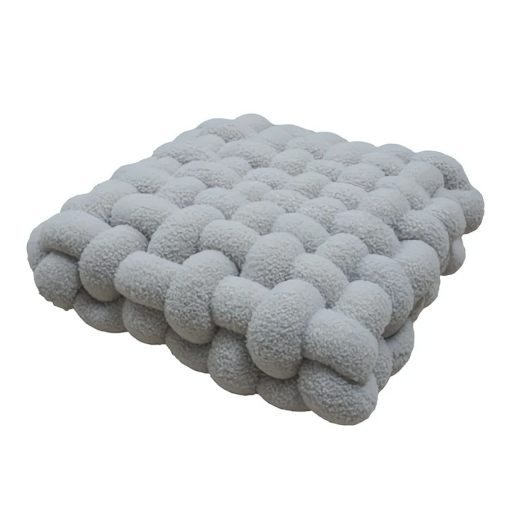 Gray textured knitted blanket on a white background