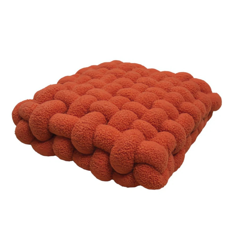 Red textured cushion on a white background