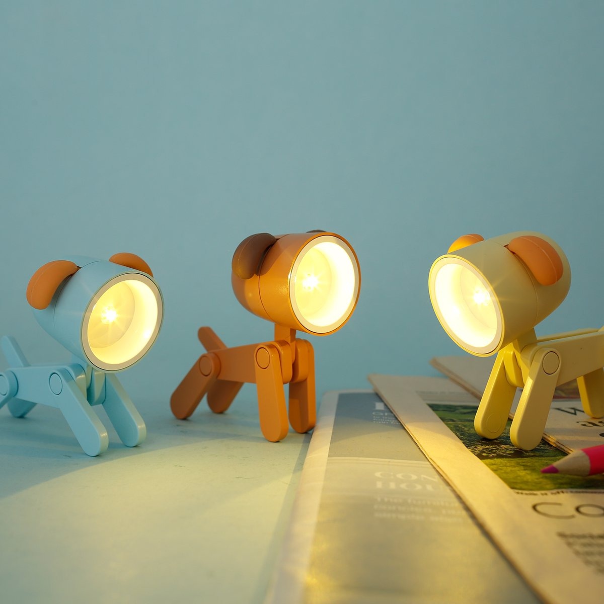 Three colorful dog-shaped lamps on a light blue background