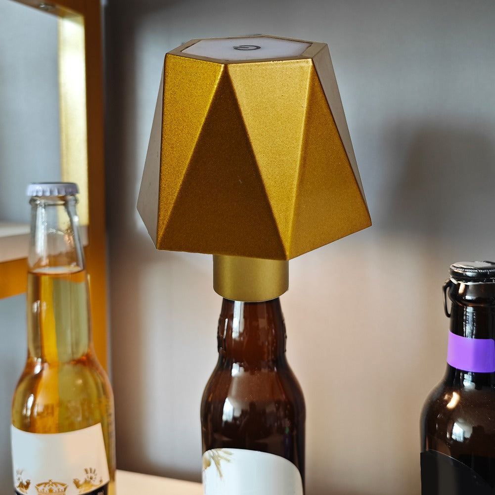 Gold geometric bottle cap on a beer bottle with a blurred background