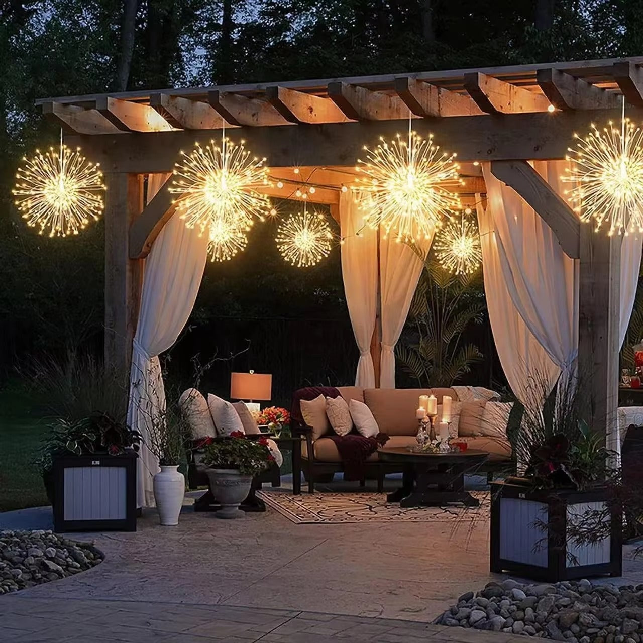 Outdoor patio with wooden pergola, string lights, and outdoor furniture at night.