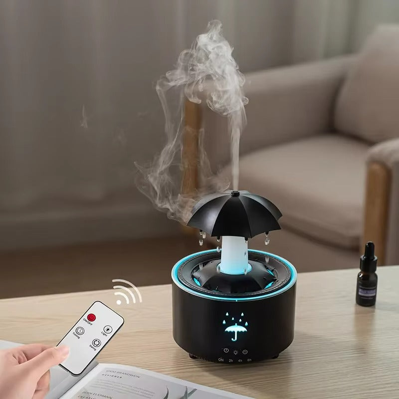 Black umbrella-shaped diffuser with steam on a table, remote control nearby