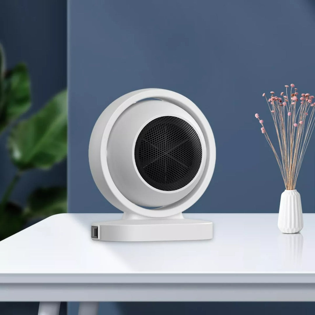White circular device on a white surface with a blue wall and plant in the background