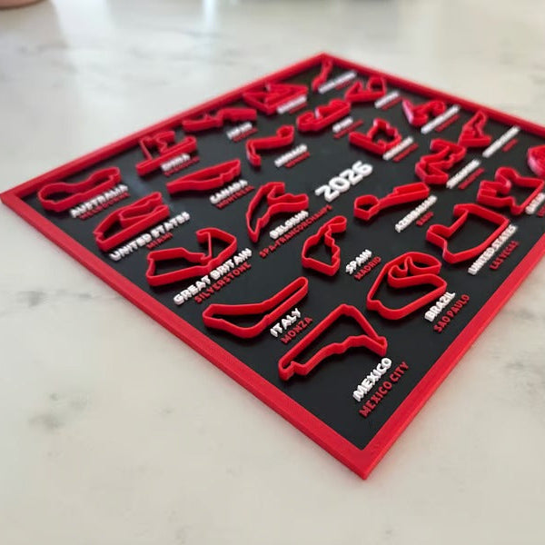 Red and black tool kit with various tools on a light-colored surface