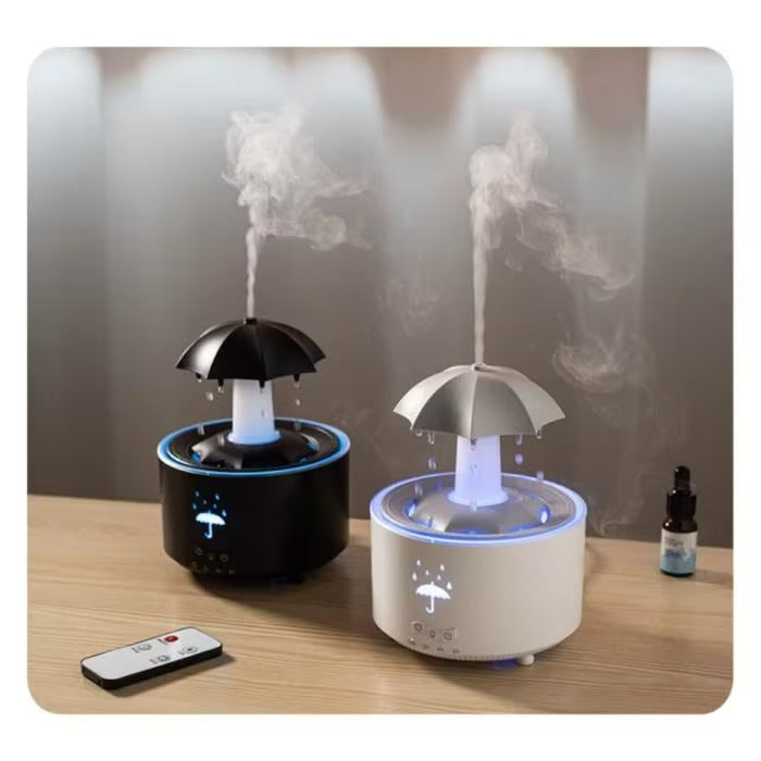 Two umbrella-shaped humidifiers on a wooden surface with a remote control.